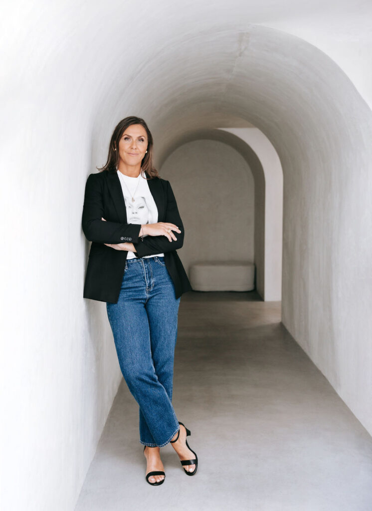 Rach Taylor standing in arch shaped white passage way.